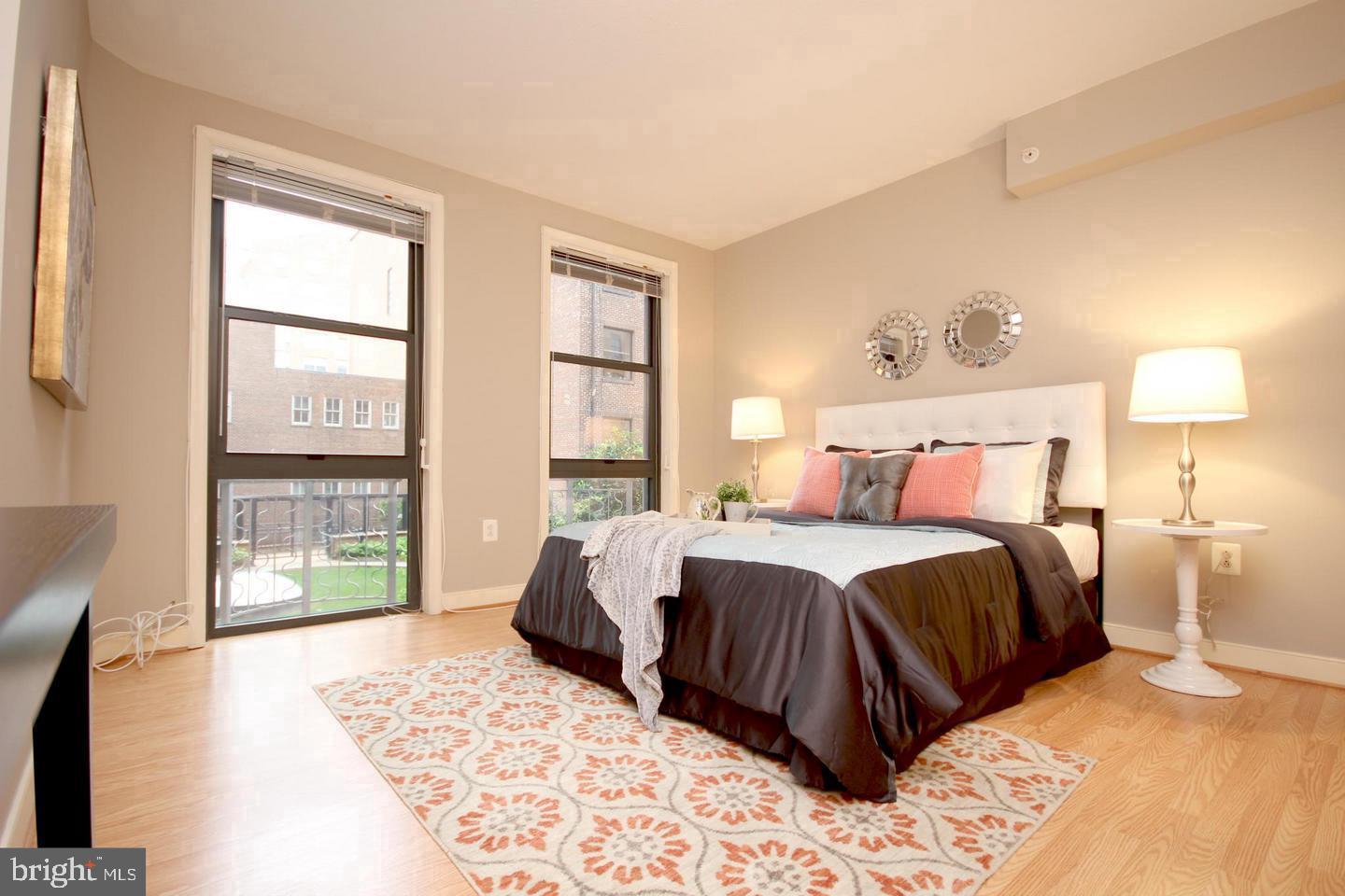 616 E Street Northwest, Unit 246 Washington, DC 20004 - Photo 3 of 40 a bedroom with a large bed and a window