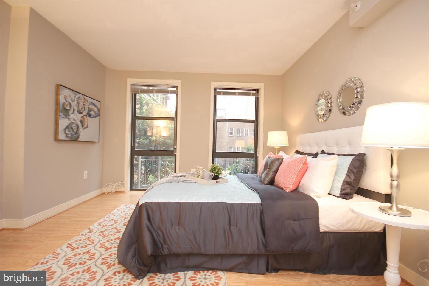 616 E Street Northwest, Unit 246 Washington, DC 20004 - Photo 4 of 40 a bedroom with a bed and a night stand