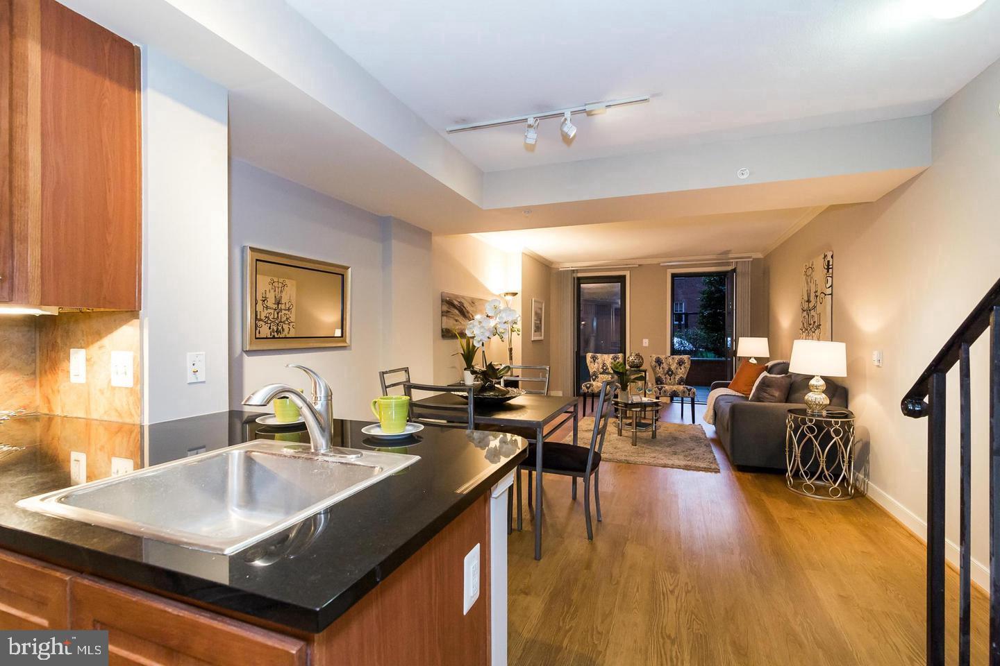 616 E Street Northwest, Unit 246 Washington, DC 20004 - Photo 6 of 40 a living room with furniture and a wooden floor