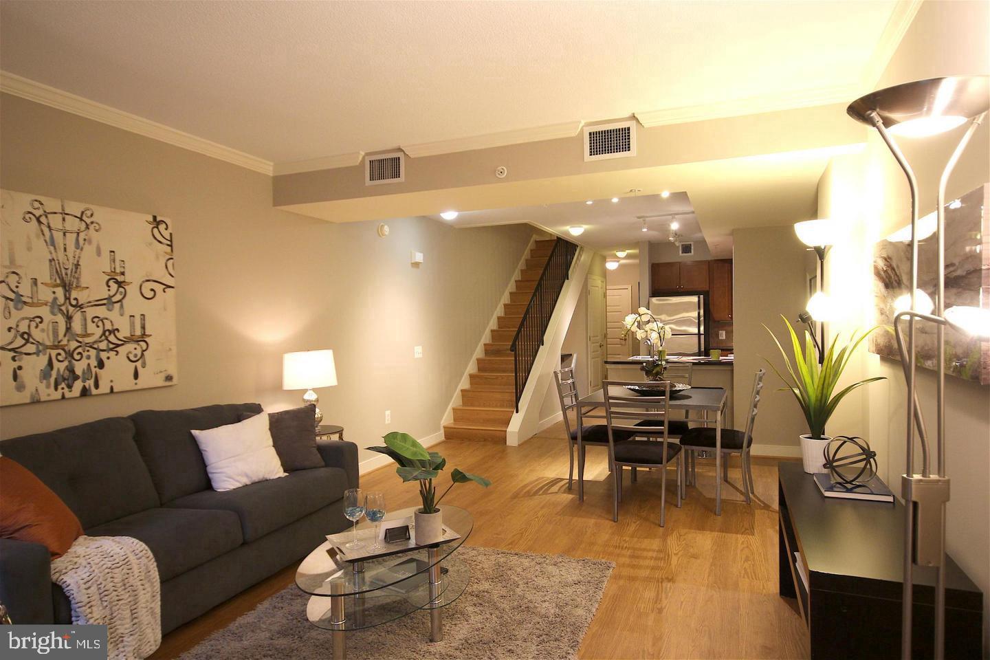 616 E Street Northwest, Unit 246 Washington, DC 20004 - Photo 9 of 40 a living room with furniture and wooden floor