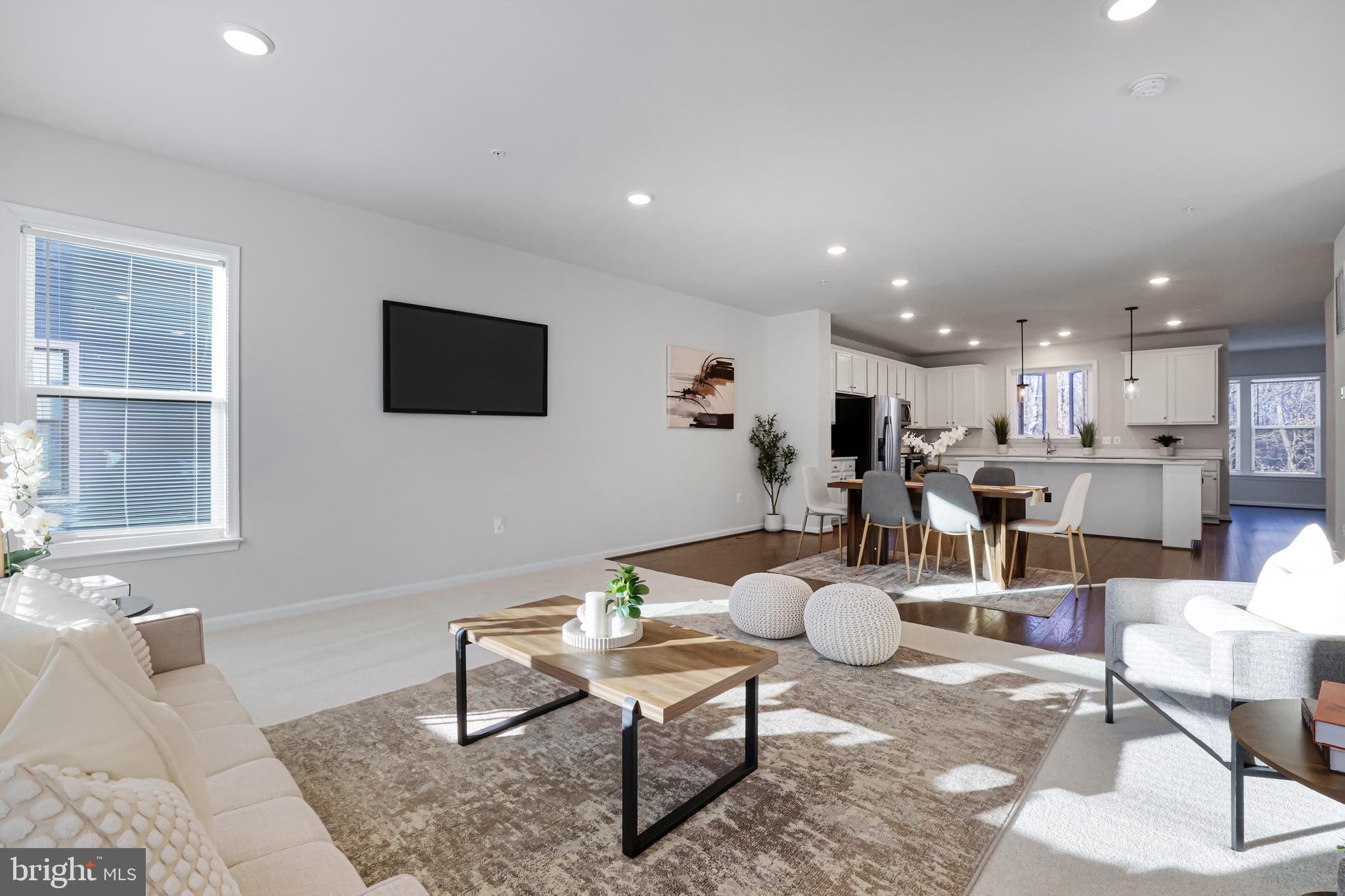 3238 Watershed Boulevard Laurel, MD 20724 - Photo 15 of 79 a living room with furniture a flat screen tv and kitchen view