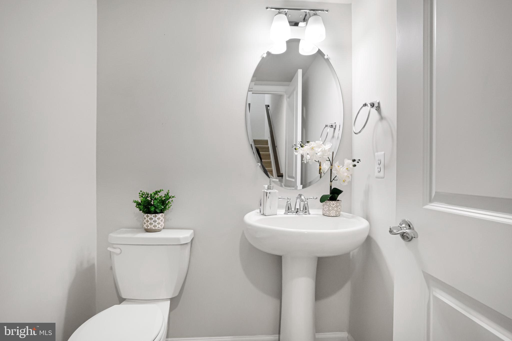 3238 Watershed Boulevard Laurel, MD 20724 - Photo 19 of 79 a bathroom with a toilet sink and mirror