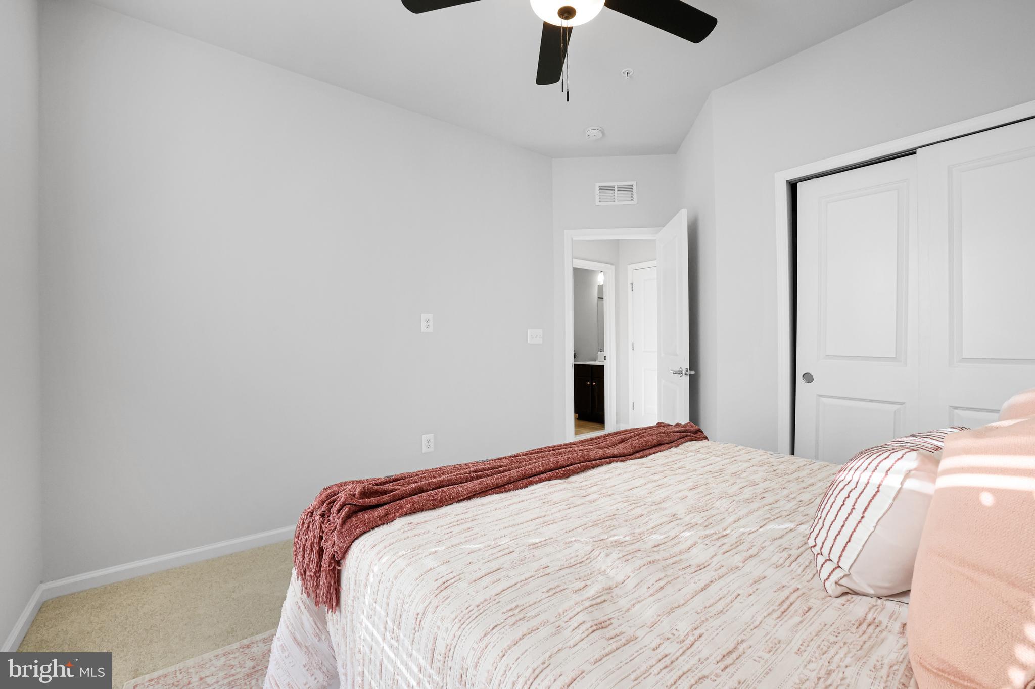 3238 Watershed Boulevard Laurel, MD 20724 - Photo 32 of 79 a bedroom with a bed and a chandelier