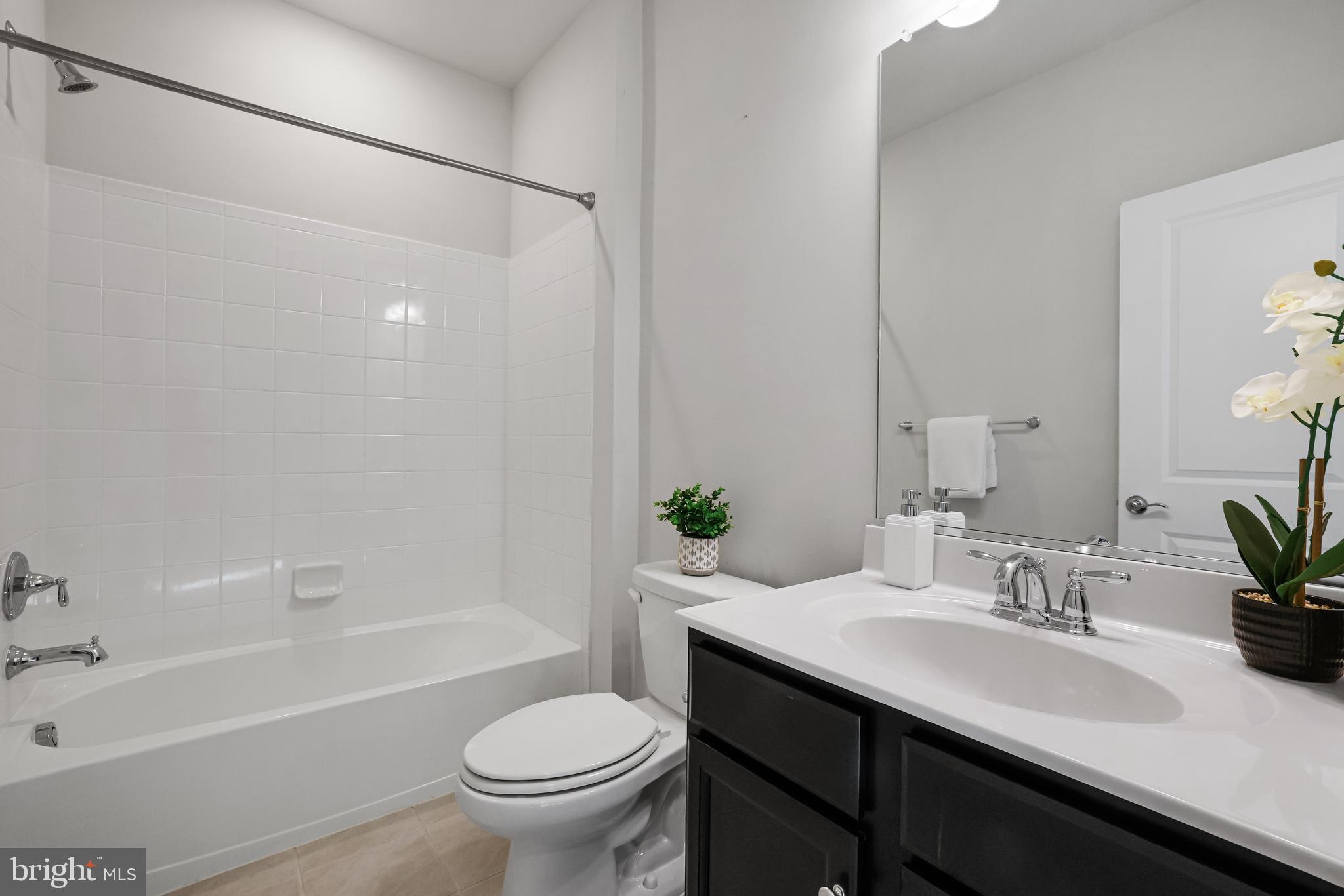 3238 Watershed Boulevard Laurel, MD 20724 - Photo 35 of 79 a bathroom with a sink a toilet and bathtub