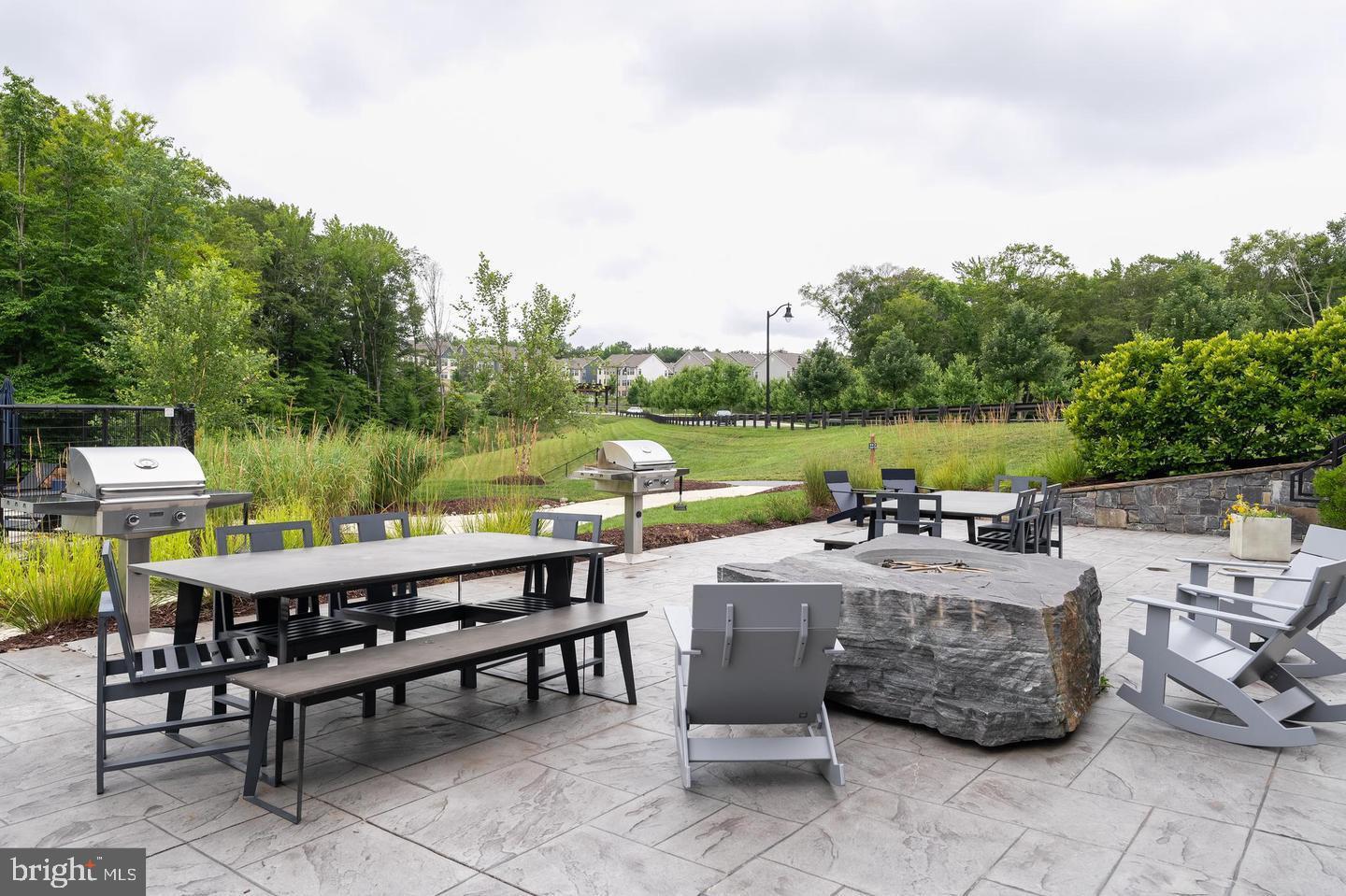 3238 Watershed Boulevard Laurel, MD 20724 - Photo 61 of 79 a view of a patio with table and chairs potted plants with wooden floor and fence