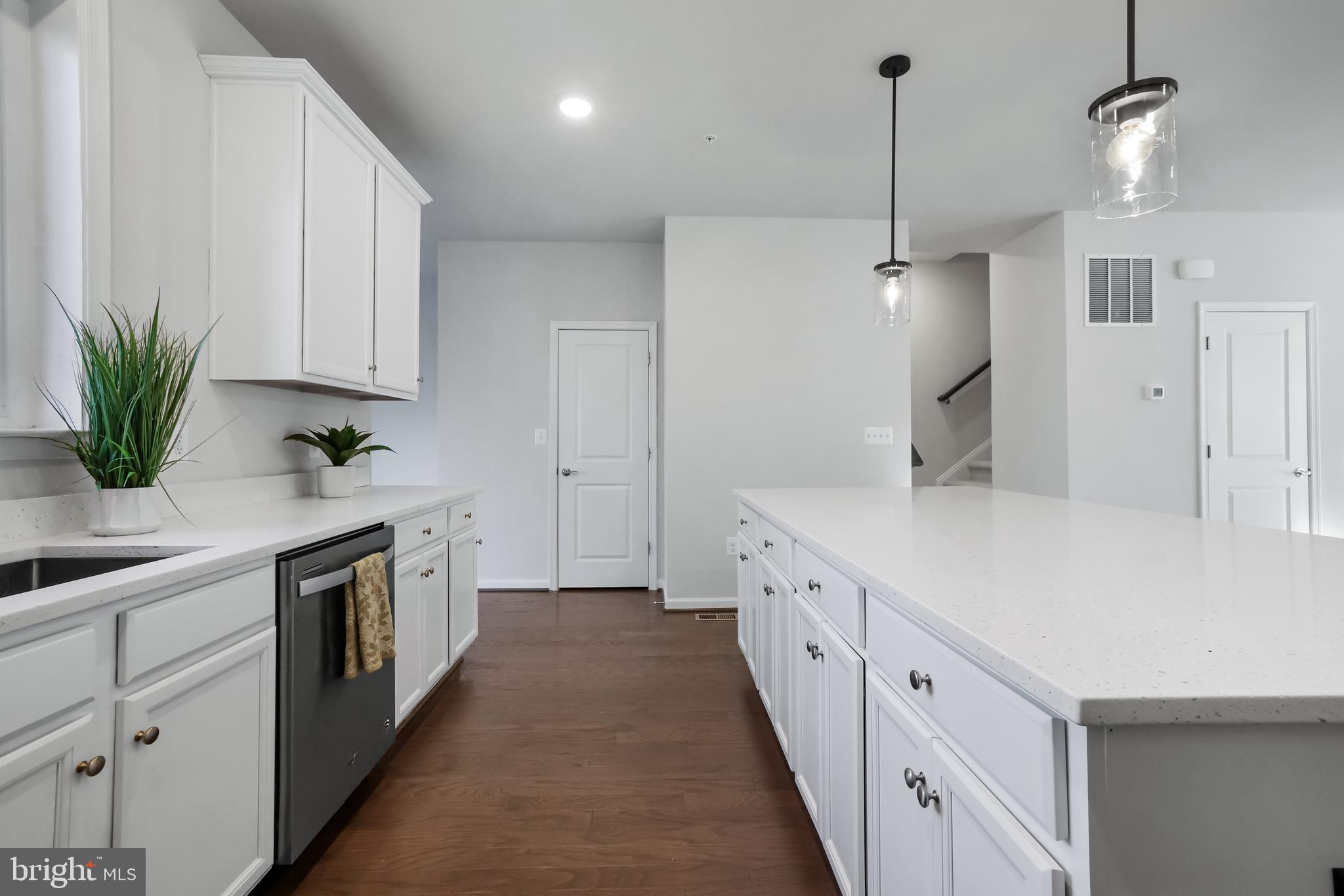 3238 Watershed Boulevard Laurel, MD 20724 - Photo 8 of 79 a kitchen with white cabinets and white appliances