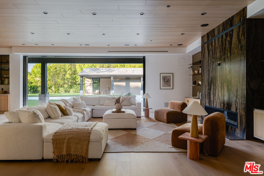 23615 Long Valley Road Hidden Hills, CA 91302 - Photo 24 of 75 a living room with furniture and a large window