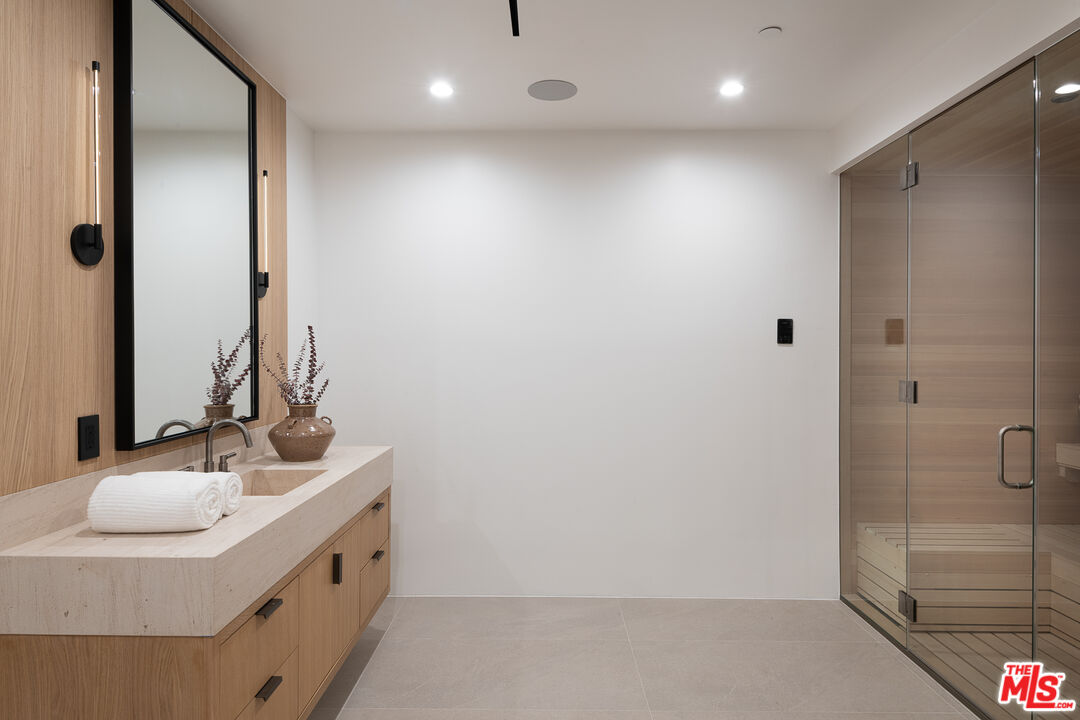 23615 Long Valley Road Hidden Hills, CA 91302 - Photo 48 of 75 a bathroom with a sink and a mirror