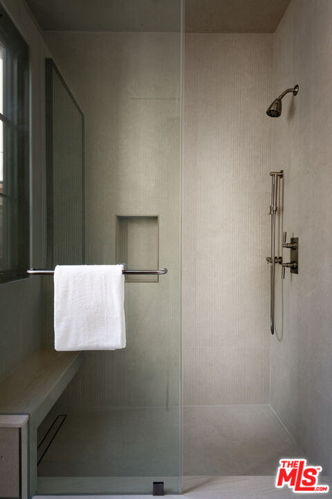 23615 Long Valley Road Hidden Hills, CA 91302 - Photo 56 of 75 a bathroom with a shower and a sink
