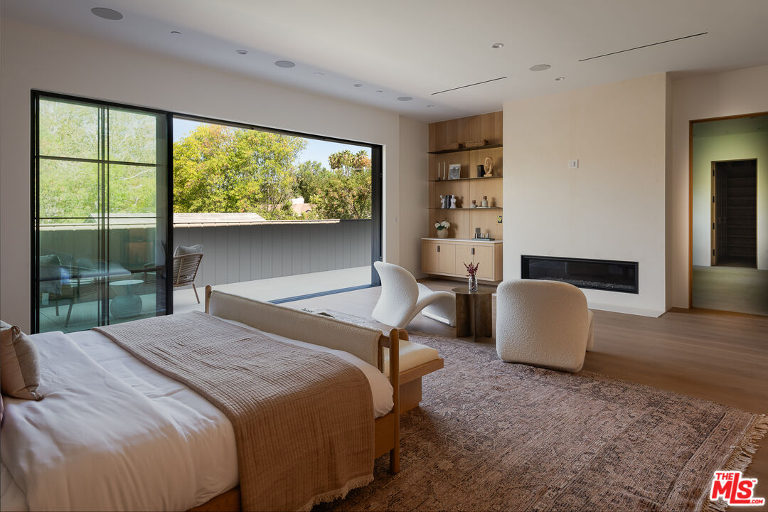 23615 Long Valley Road Hidden Hills, CA 91302 - Photo 62 of 75 a bedroom with a large bed and a large window