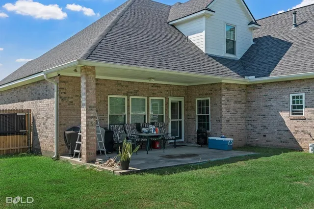 a view of a house with a yard and sitting area
