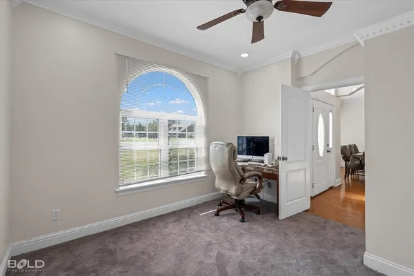 a view of a workspace with furniture and a window