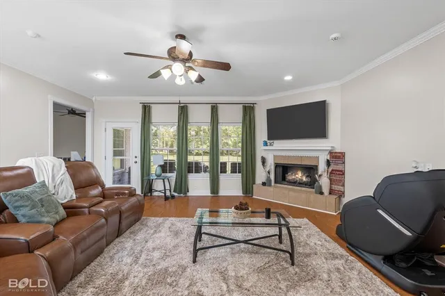 a living room with furniture fireplace and flat screen tv