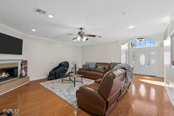 a living room with furniture a fireplace and a flat screen tv