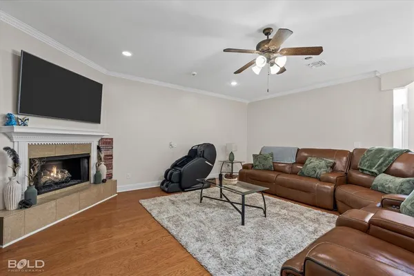 a living room with furniture a flat screen tv and a fireplace