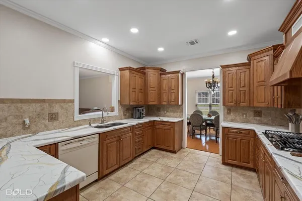 a kitchen with stainless steel appliances granite countertop a sink stove and cabinets