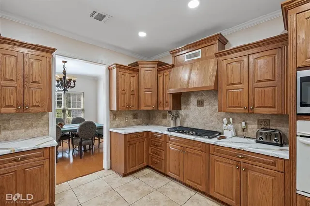 a kitchen with stainless steel appliances granite countertop a sink dishwasher stove and cabinets
