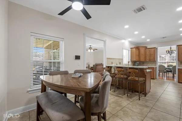 a view of a dining room with furniture and a window