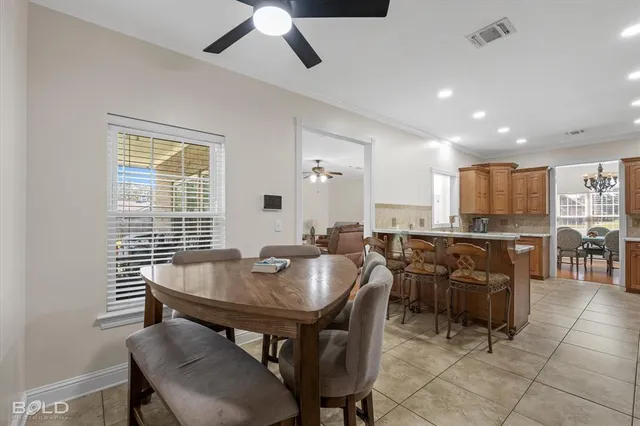a view of a dining room with furniture and a window