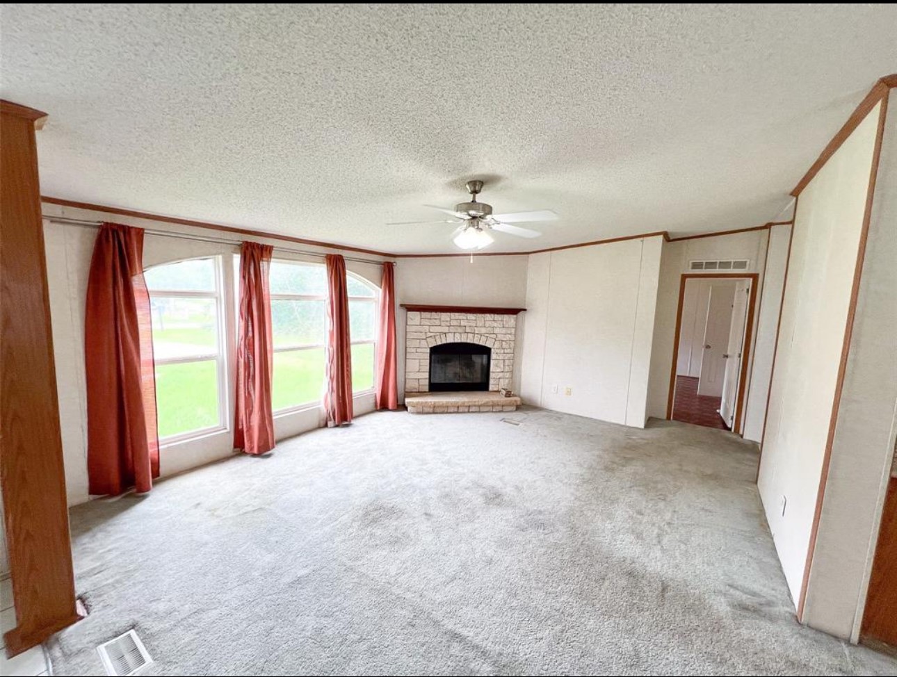 24450 Cunningham Drive Porter, TX 77365 - Photo 2 of 9 a view of empty room with fireplace and fan