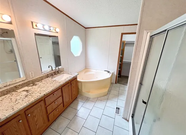 a bathroom with a granite countertop sink mirror vanity and toilet