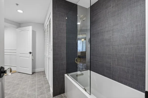 a bathroom with a tub and a shower