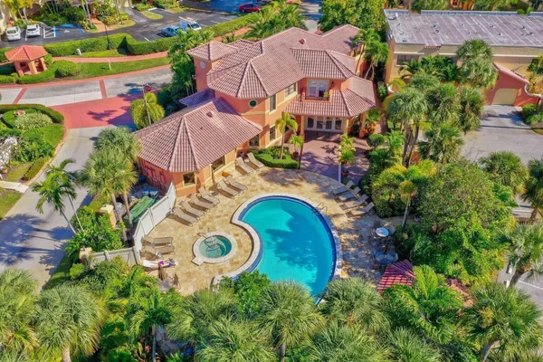 an aerial view of residential houses with outdoor space and swimming pool