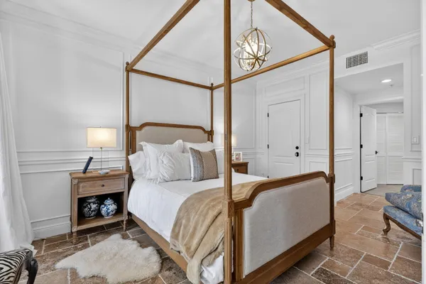 a bedroom with a bed and a lamp