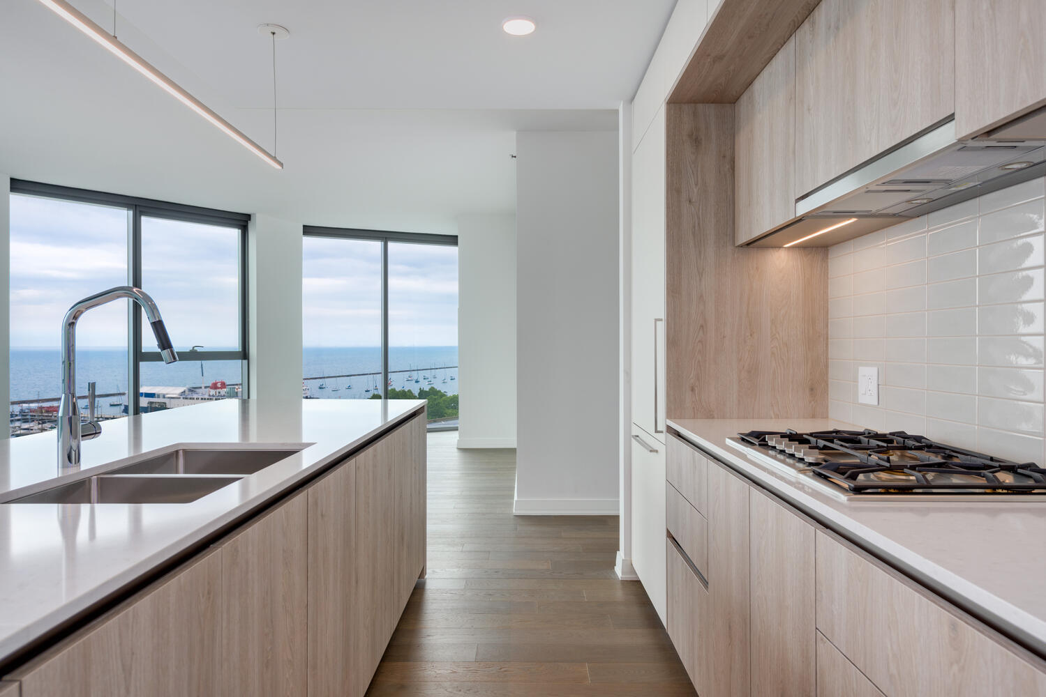211 North Harbor Drive, Unit 2002 Chicago, IL 60601 - Photo 11 of 30 a kitchen with kitchen island a sink stove and cabinets