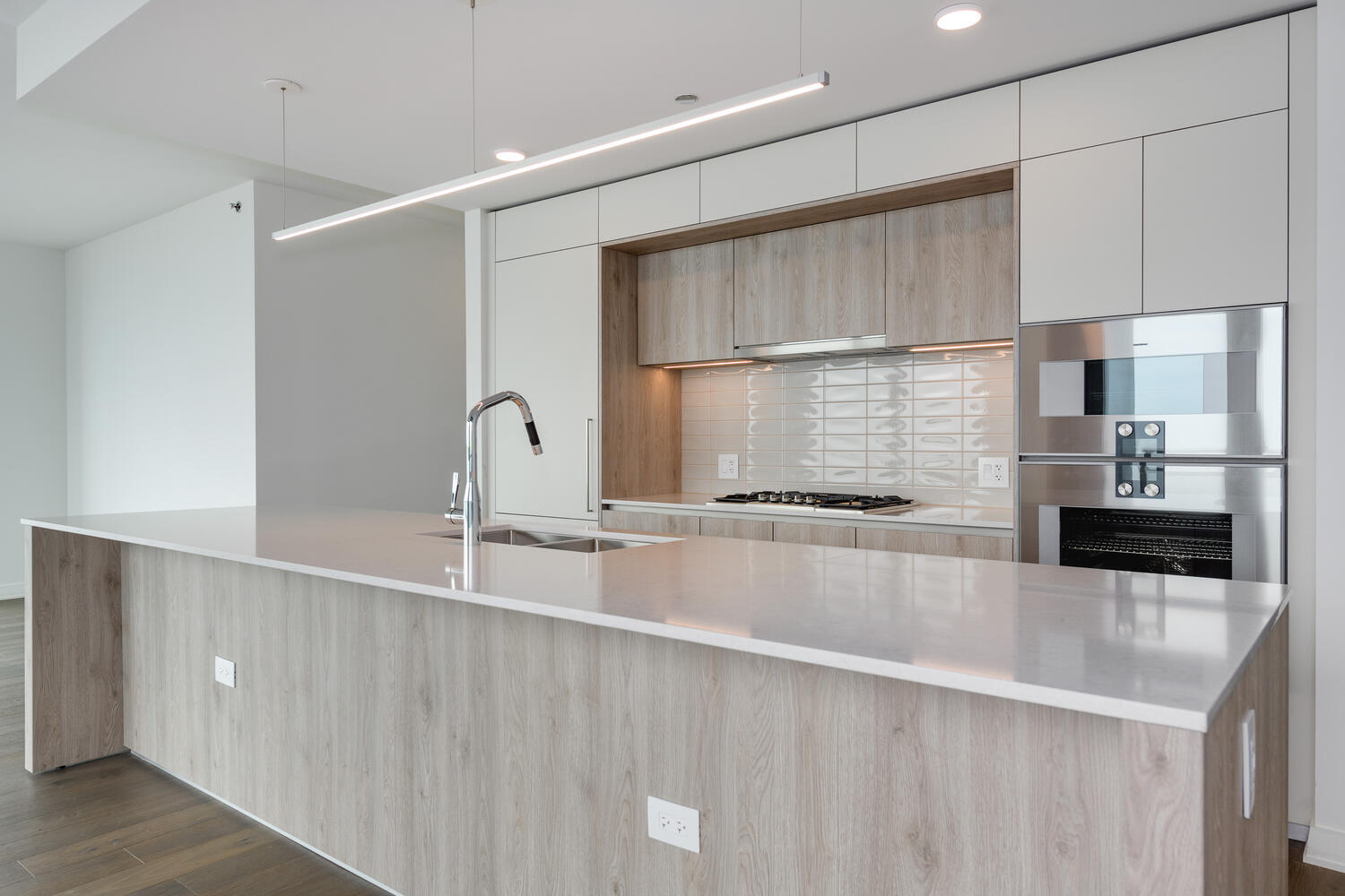211 North Harbor Drive, Unit 2002 Chicago, IL 60601 - Photo 9 of 30 a large kitchen with kitchen island a sink stainless steel appliances and cabinets