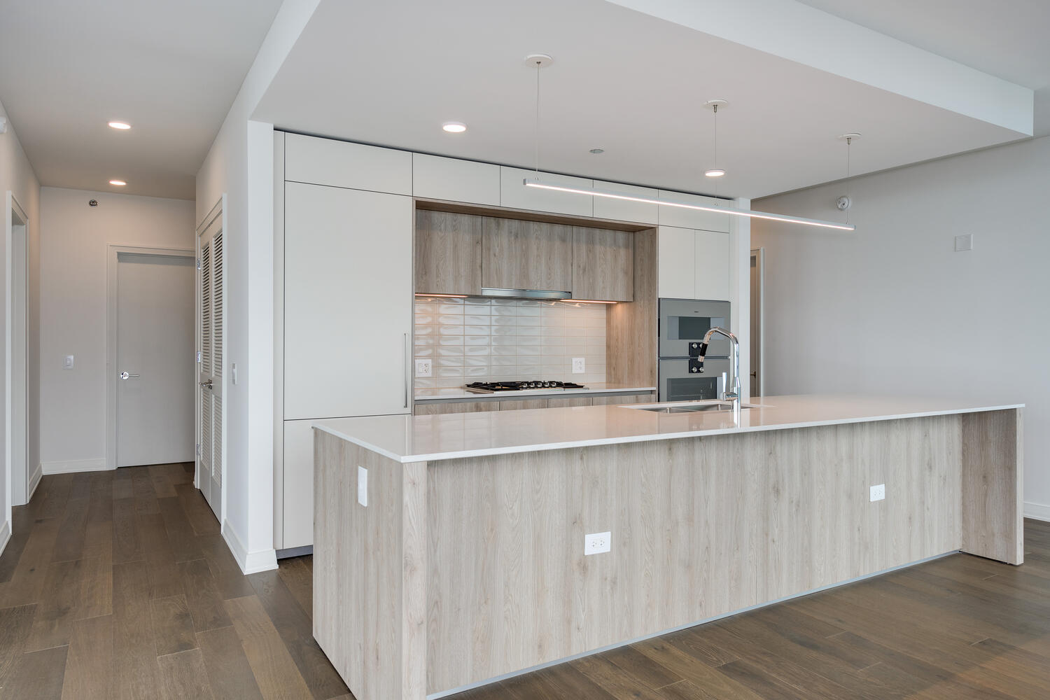 211 North Harbor Drive, Unit 2002 Chicago, IL 60601 - Photo 10 of 30 a kitchen with a sink a refrigerator and wooden cabinets