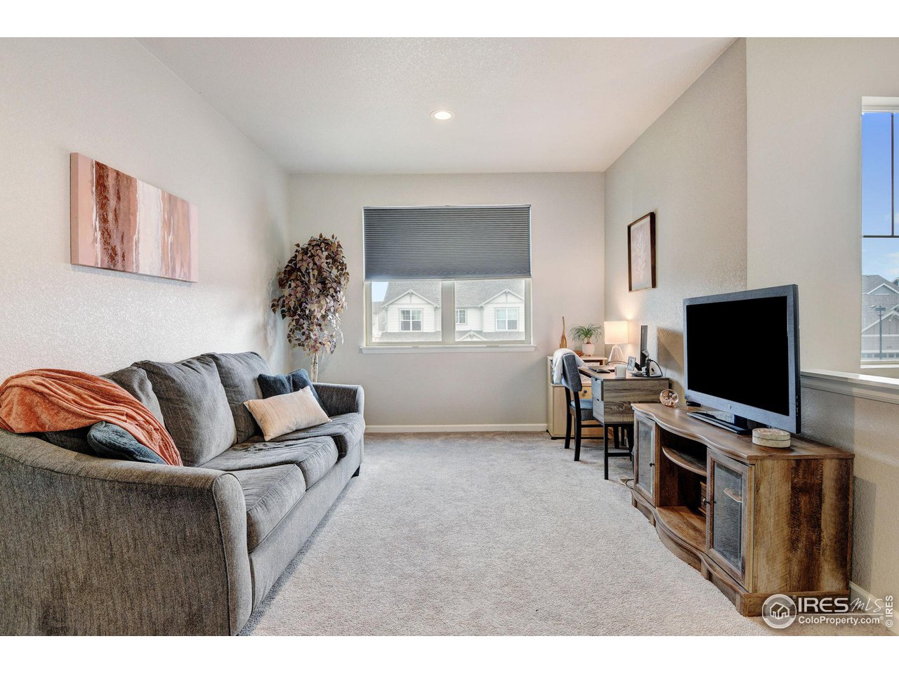 620 Wagon Bend Road Berthoud, CO 80513 - Photo 19 of 39 a living room with furniture and a flat screen tv