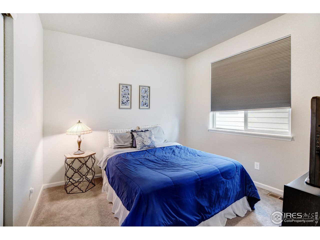 620 Wagon Bend Road Berthoud, CO 80513 - Photo 27 of 39 a bedroom with a bed a dresser and a window