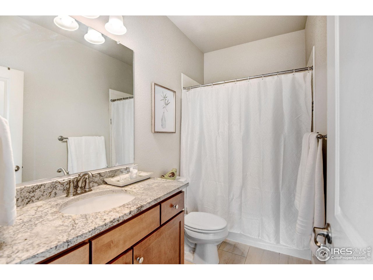 620 Wagon Bend Road Berthoud, CO 80513 - Photo 28 of 39 a bathroom with a granite countertop sink and a mirror