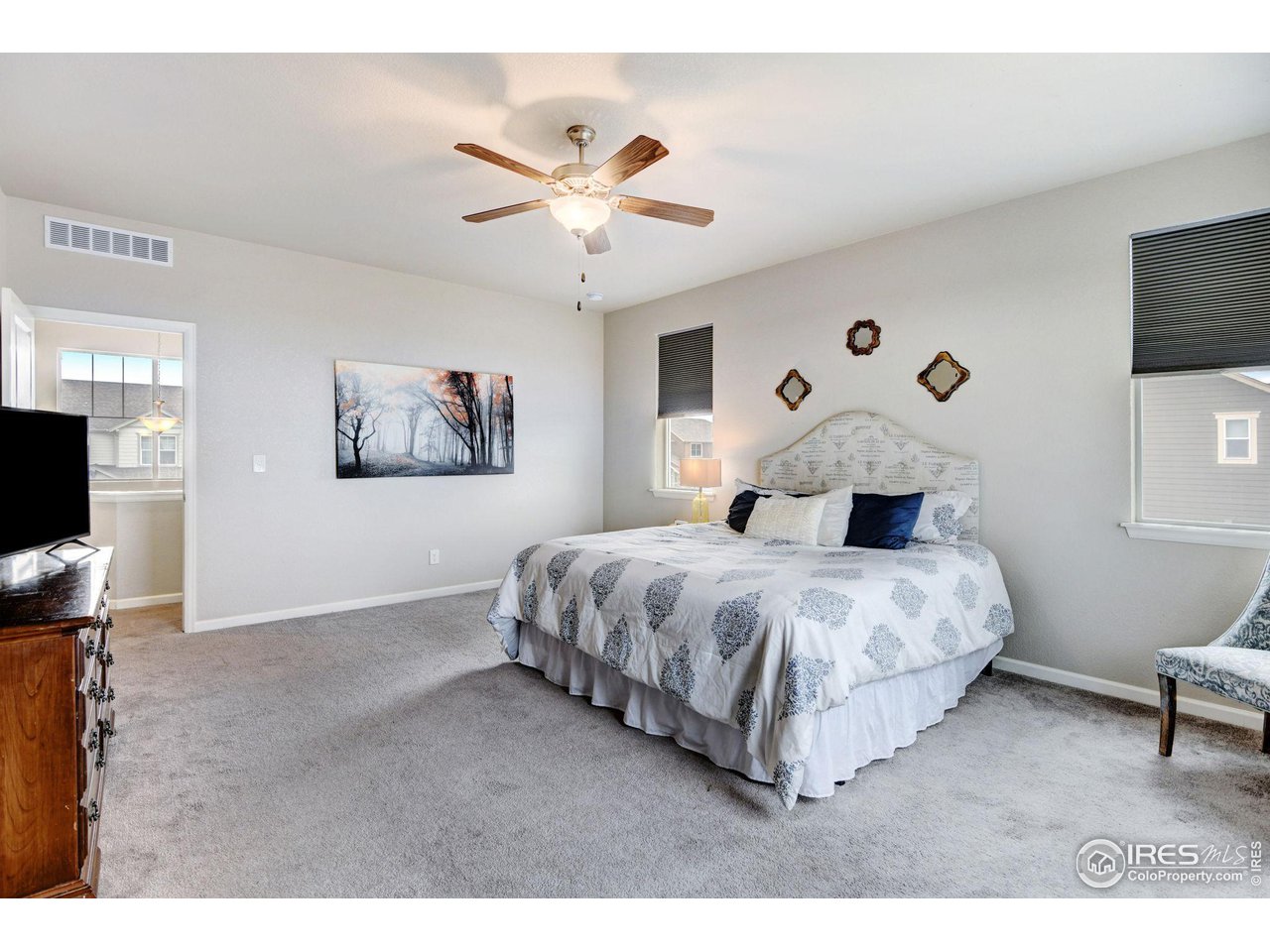 620 Wagon Bend Road Berthoud, CO 80513 - Photo 32 of 39 a bedroom with a bed and a flat screen tv