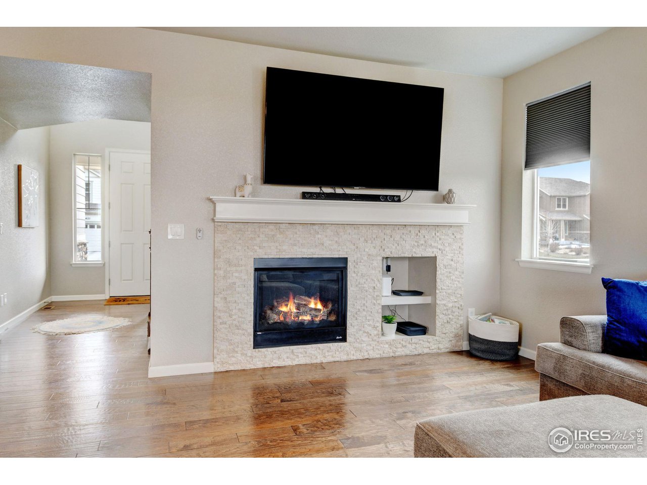 620 Wagon Bend Road Berthoud, CO 80513 - Photo 8 of 39 a living room with furniture a flat screen tv and a fireplace
