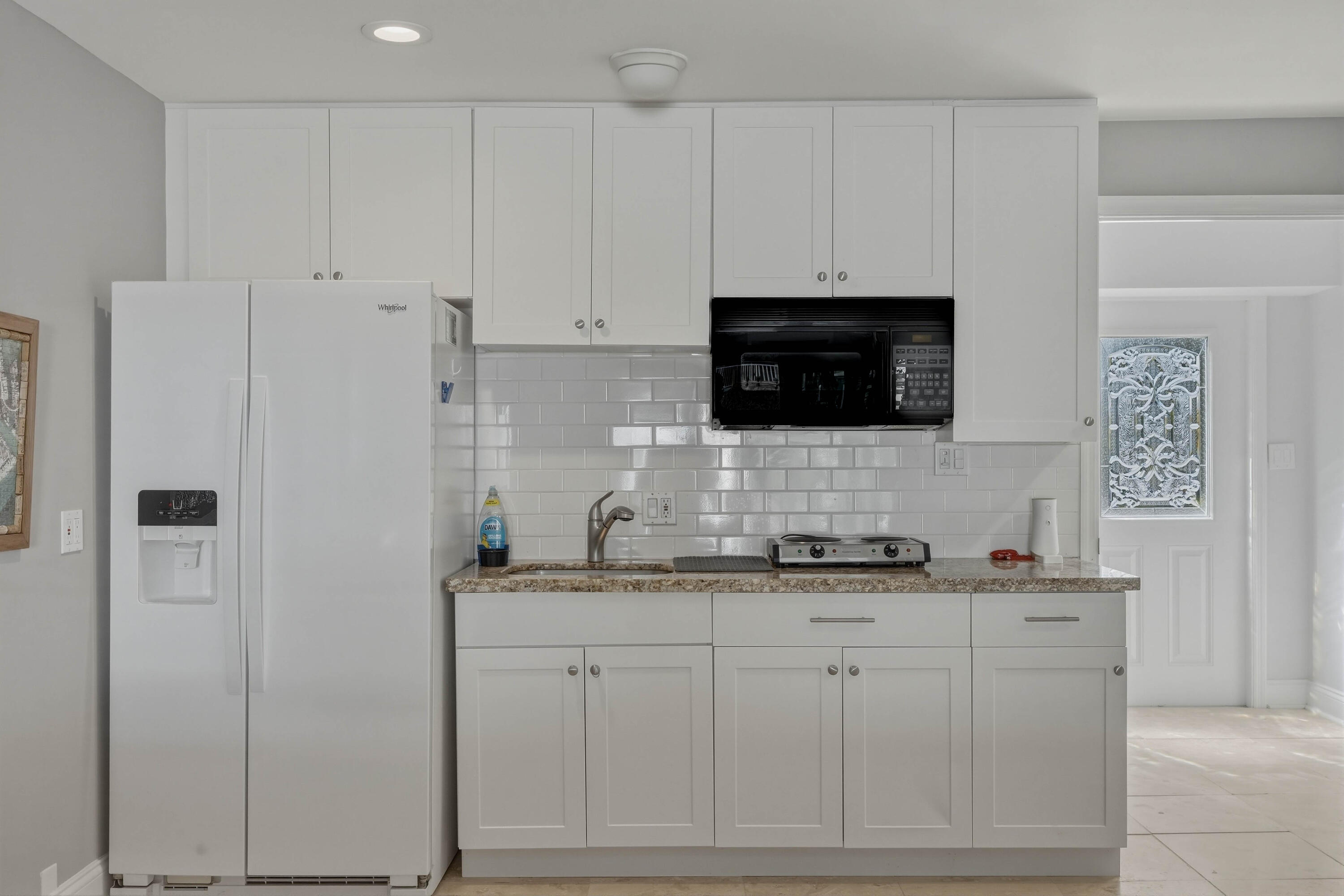 320 5th Street Key Colony Beach, FL 33051 - Photo 32 of 53 a kitchen with stainless steel appliances granite countertop white cabinets sink and a granite counter top