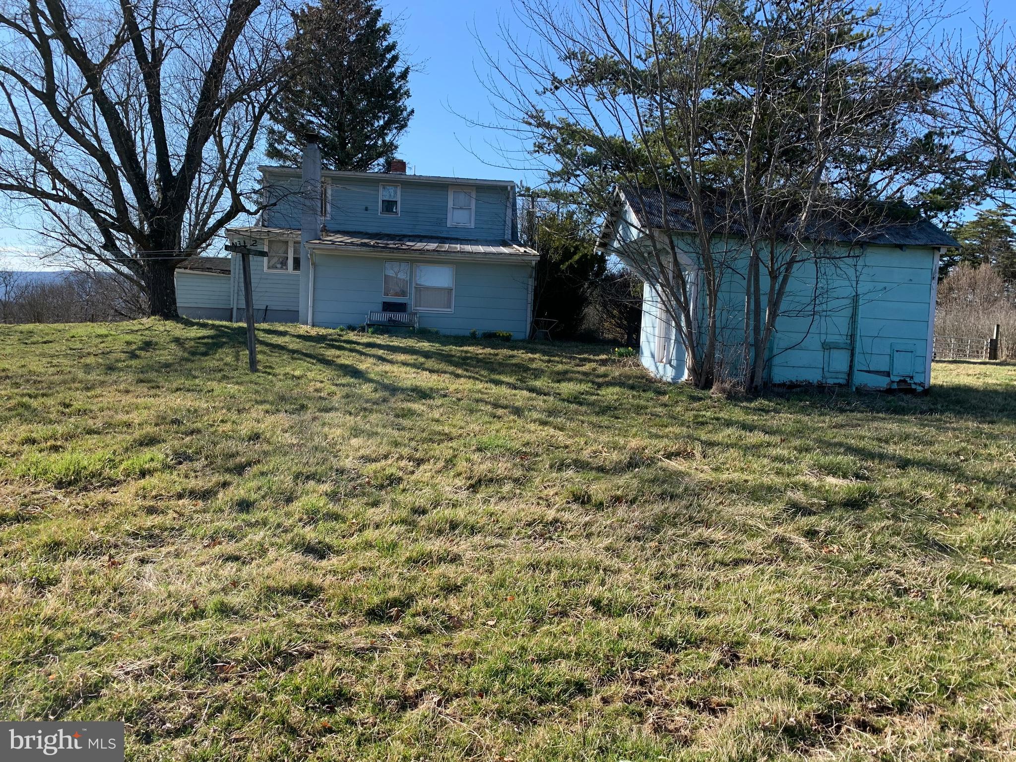 11169 Winchester Grade Road Berkeley Springs, WV 25411 - Photo 25 of 28 Back pf the house and storage building back yard