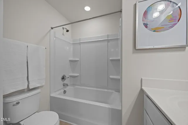 a bathroom with a bathtub a toilet and a shower