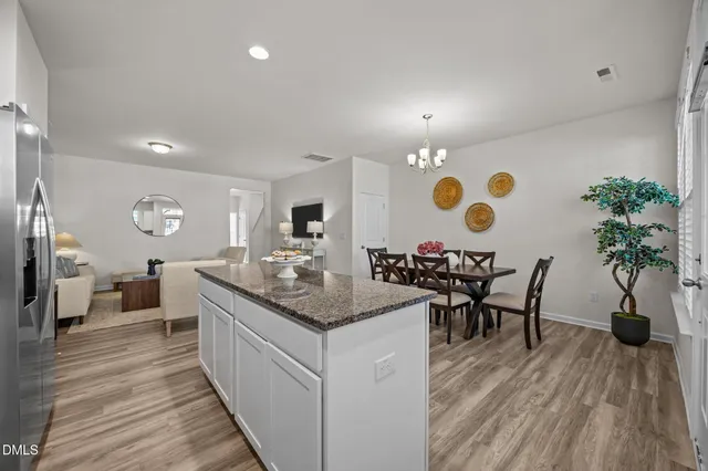 a large kitchen with a table and chairs
