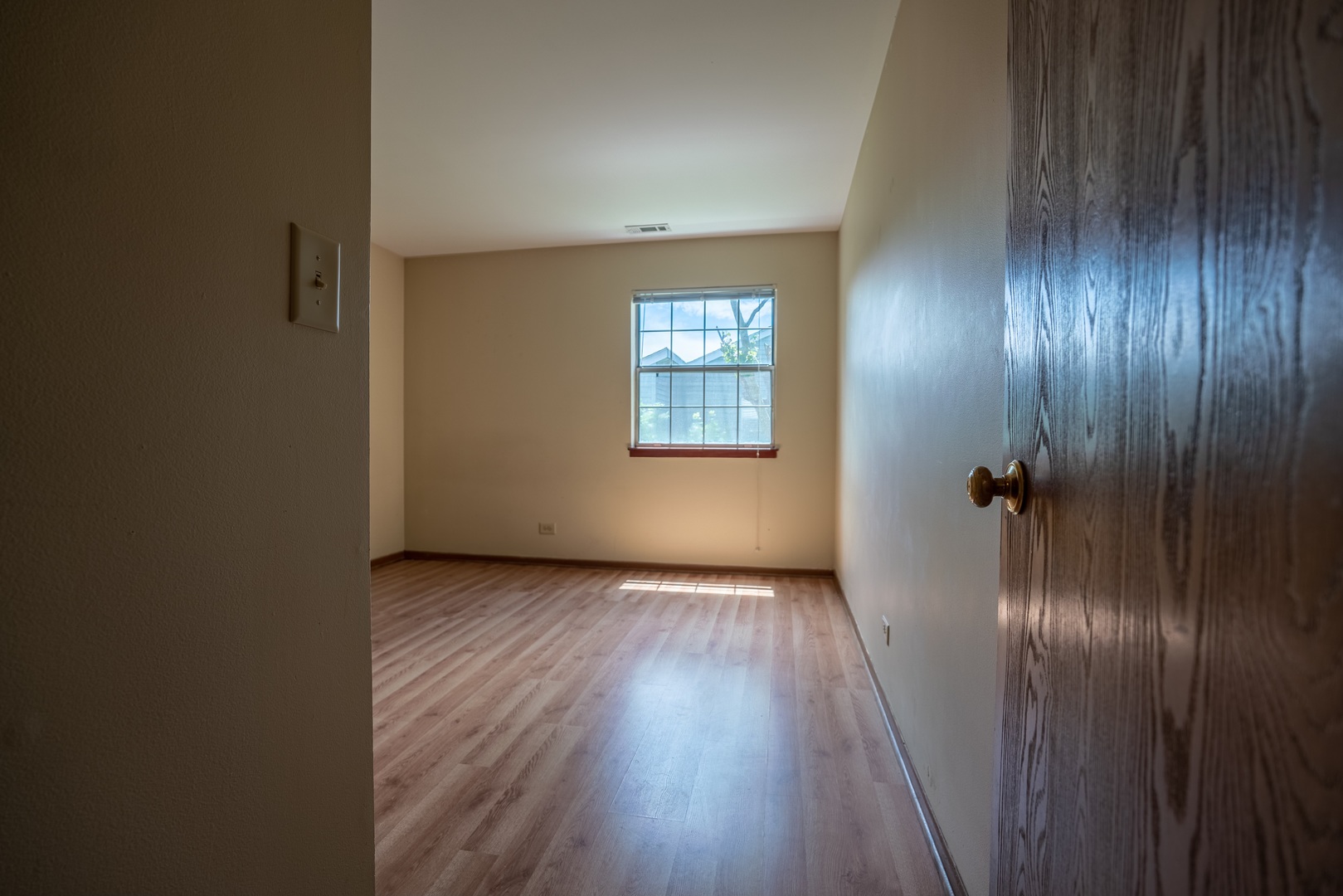 20 Gant Circle, Unit E Streamwood, IL 60107 - Photo 12 of 20 an empty room with wooden floor and a window