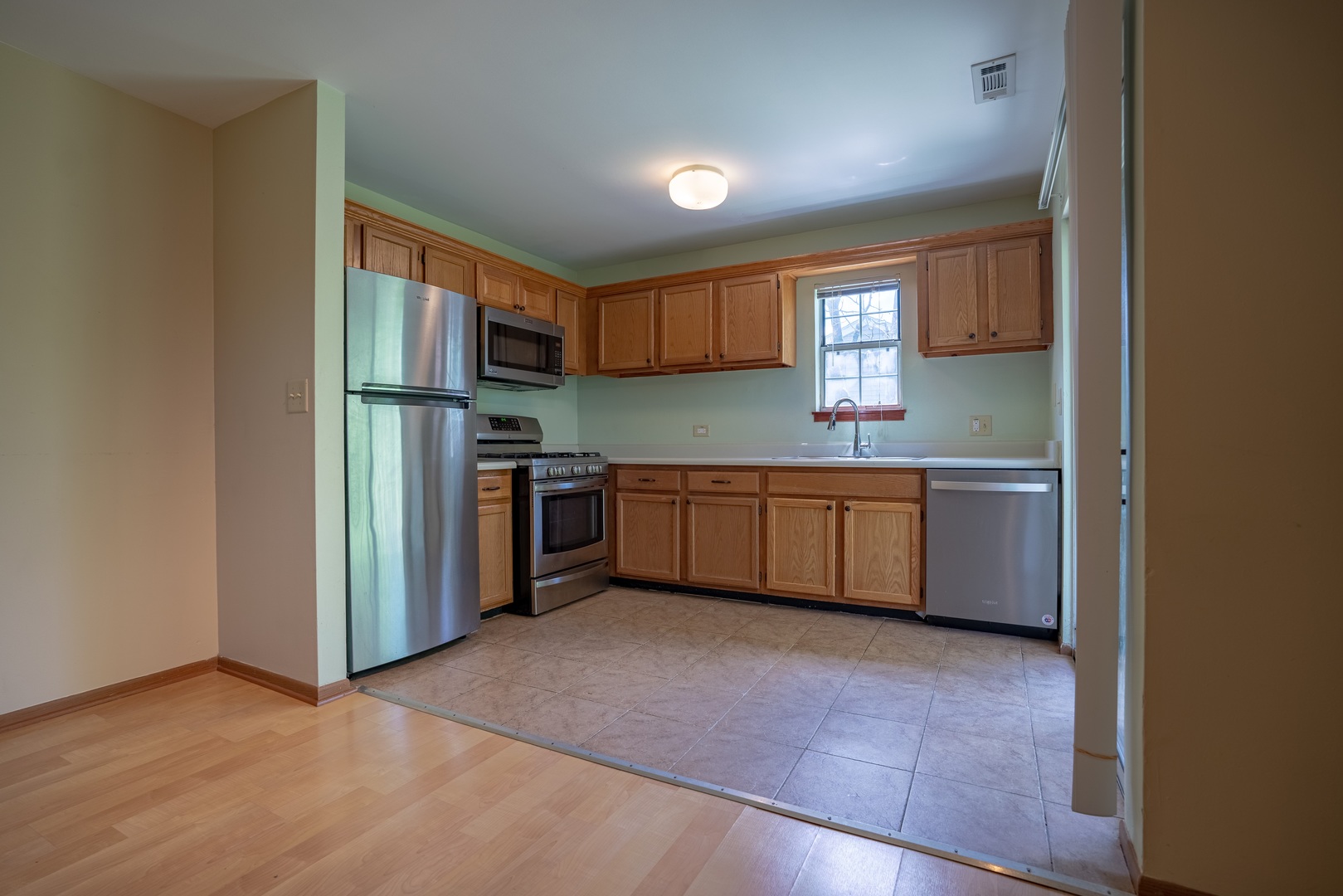 20 Gant Circle, Unit E Streamwood, IL 60107 - Photo 5 of 20 a kitchen with stainless steel appliances a sink and a refrigerator