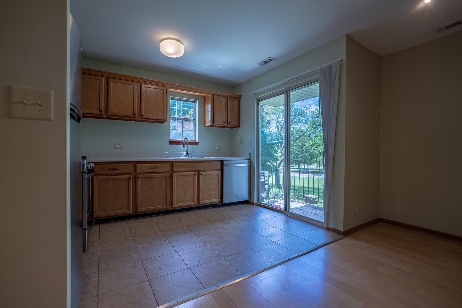 20 Gant Circle, Unit E Streamwood, IL 60107 - Photo 6 of 20 a kitchen with stainless steel appliances granite countertop a stove a sink and a refrigerator with wooden floor