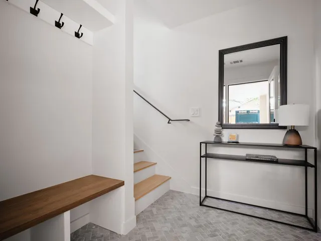 a view of an entryway with wooden floor