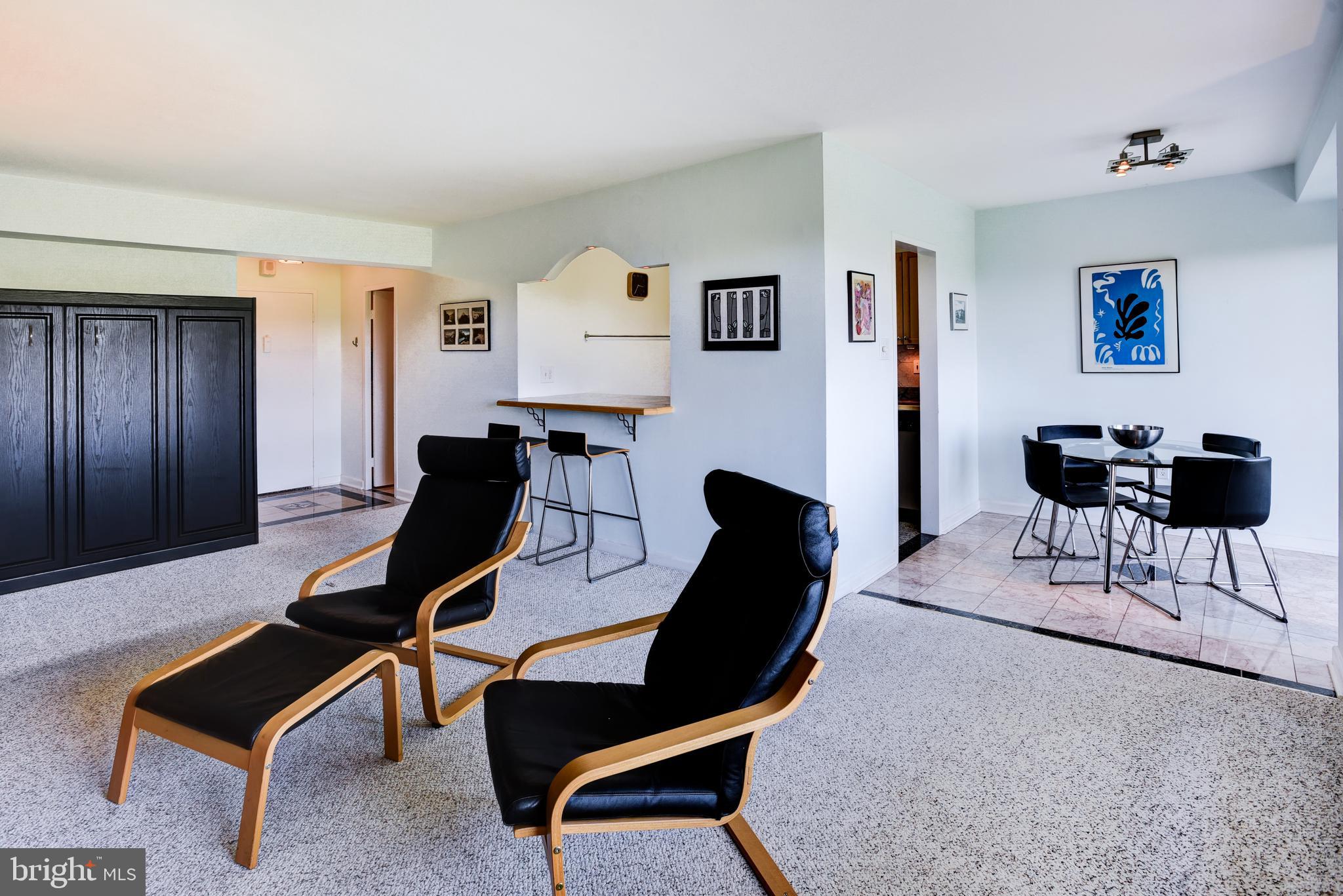 4201 Cathedral Avenue Northwest, Unit 1411E Washington, DC 20016 - Photo 12 of 66 a living room with furniture and a piano