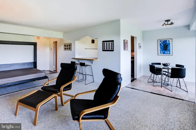 a bedroom with furniture and a air conditioner vent