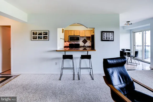 a living room with furniture a large window and a flat screen tv