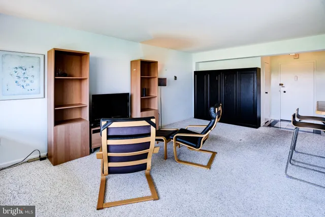 a view of room with stairs and wooden floor