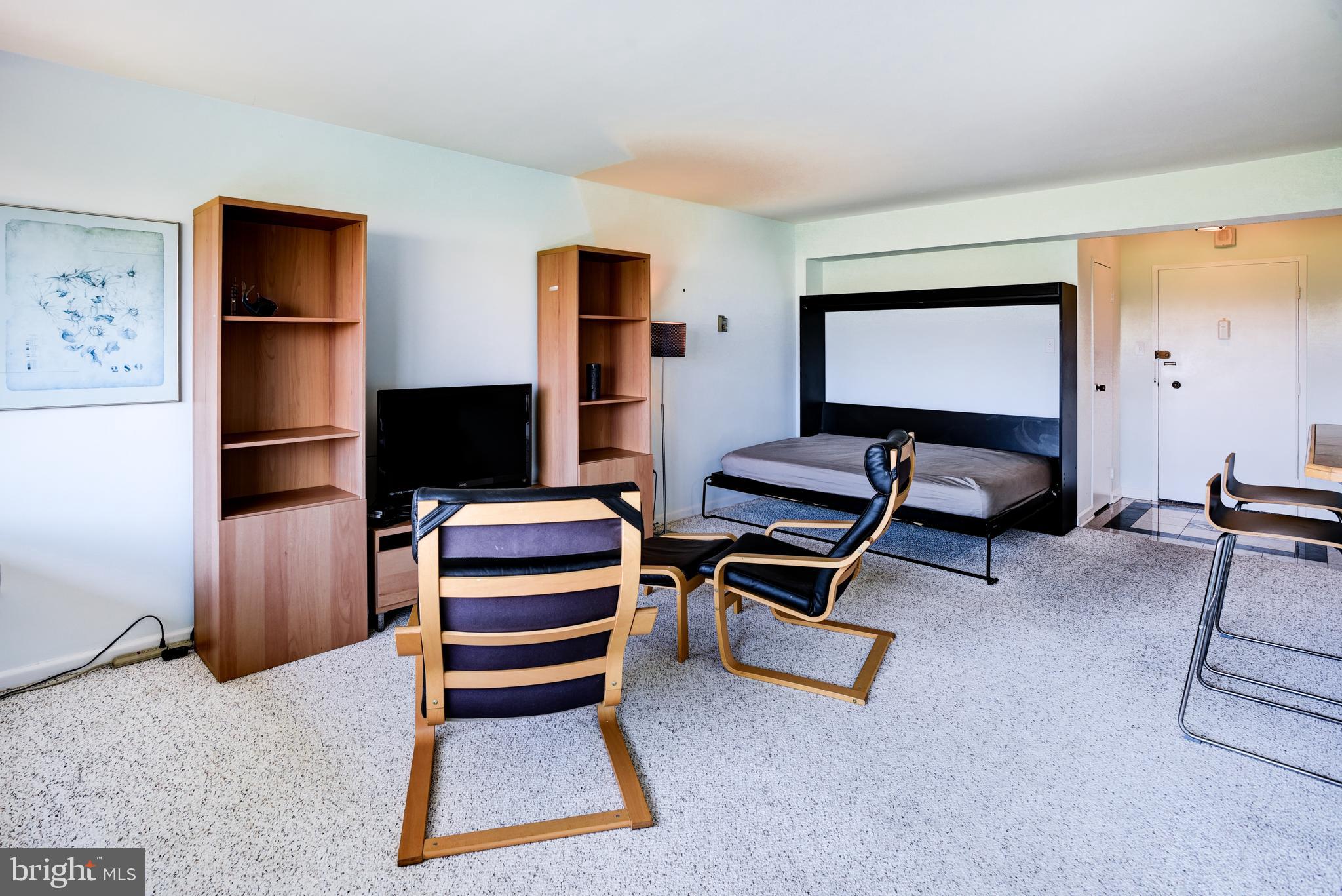 4201 Cathedral Avenue Northwest, Unit 1411E Washington, DC 20016 - Photo 16 of 66 a bedroom with furniture and a air conditioner vent