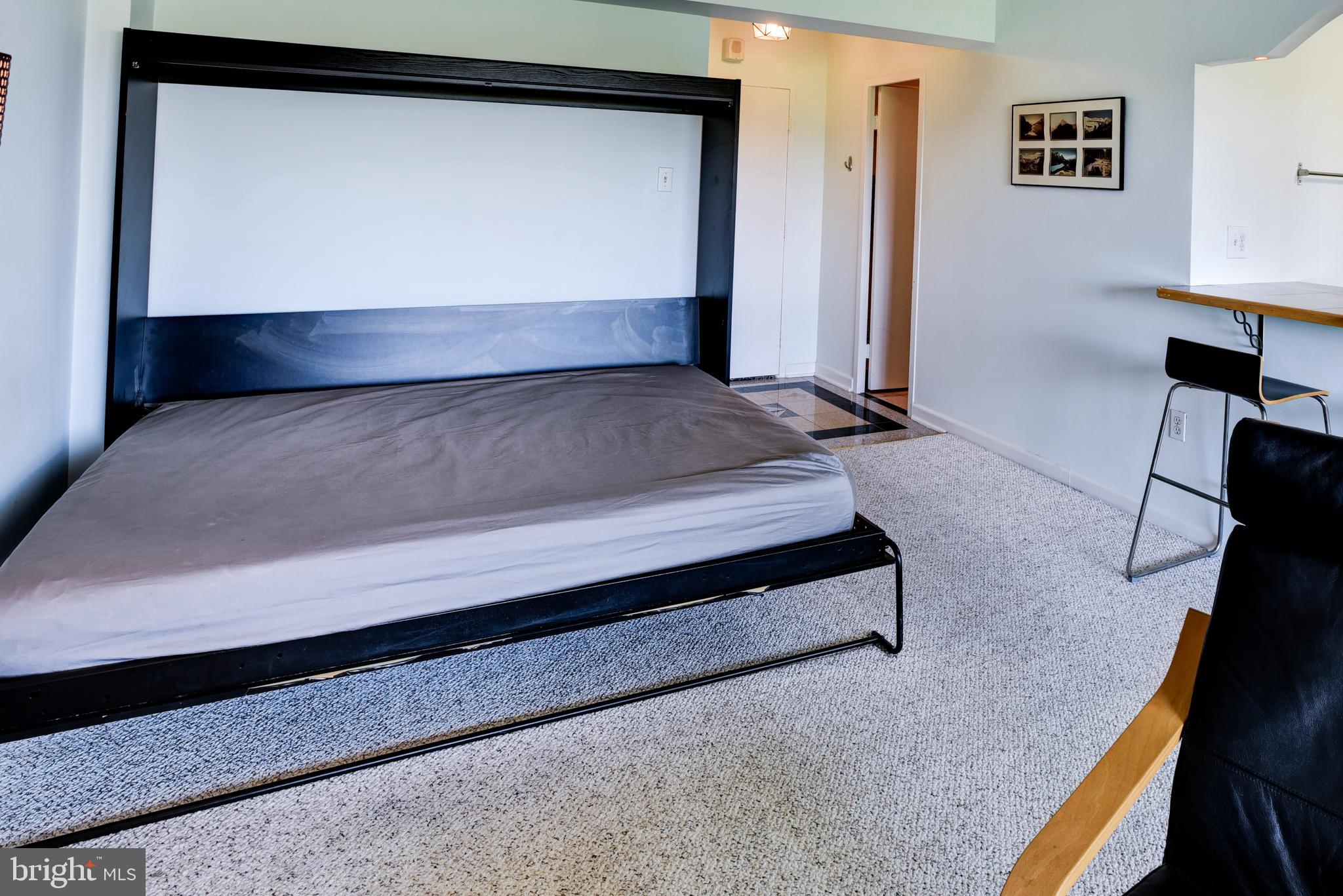 4201 Cathedral Avenue Northwest, Unit 1411E Washington, DC 20016 - Photo 18 of 66 a view of room with stairs and wooden floor